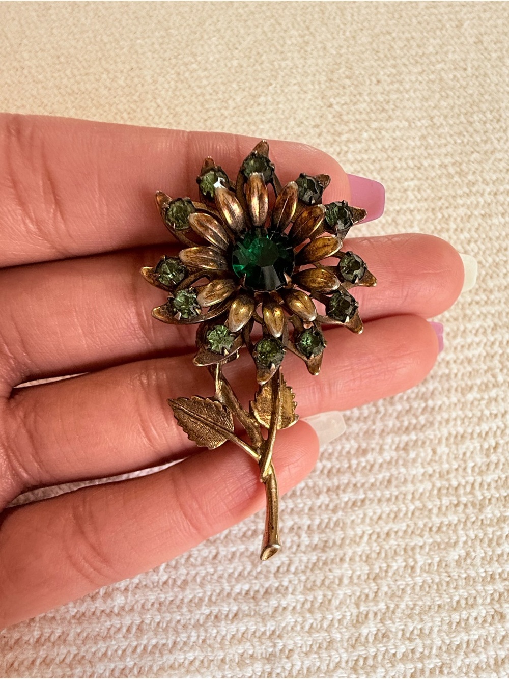 Mid-Century vintage antiqued gold-tone green rhinestone sunflower stem brooch.